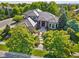 Stunning home featuring lush landscaping, a courtyard entry, and elegant architectural details on a sunny day at 5350 S Marshall St, Littleton, CO 80123