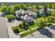 Aerial shot of a home featuring a beautiful stone and tile roof, mature trees, and meticulous landscaping at 5350 S Marshall St, Littleton, CO 80123