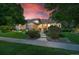 A well-maintained home featuring a lush green lawn, mature trees, and a welcoming walkway to the front door at 5350 S Marshall St, Littleton, CO 80123