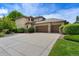 Charming home exterior with a large driveway, mature landscaping, and a three-car garage at 5350 S Marshall St, Littleton, CO 80123