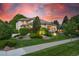 Beautifully landscaped home exterior with manicured lawn, mature trees, and charming curb appeal at 5350 S Marshall St, Littleton, CO 80123
