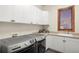 Well-lit laundry room features modern machines, lots of cabinet space, and sink at 5350 S Marshall St, Littleton, CO 80123