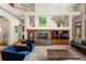 Spacious living room featuring a large fireplace and well-designed built-in shelving at 5350 S Marshall St, Littleton, CO 80123