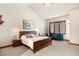 Comfortable bedroom with a vaulted ceiling, neutral colors, and plush carpet at 5350 S Marshall St, Littleton, CO 80123
