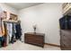 Spacious walk-in closet featuring a dark wooden dresser and ample storage space for shoes, clothes, and accessories at 5350 S Marshall St, Littleton, CO 80123