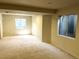 The finished basement has neutral carpet, baseboards, and paint plus windows for natural light at 5988 W Crestline Ave, Littleton, CO 80123
