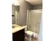 Bathroom featuring a glass shower door, and large mirror at 5988 W Crestline Ave, Littleton, CO 80123