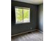 Bedroom featuring neutral carpet and a window with a view of the outdoors at 5988 W Crestline Ave, Littleton, CO 80123
