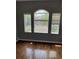 Bedroom with hardwood floors, gray walls, and windows with views of the outdoors at 5988 W Crestline Ave, Littleton, CO 80123