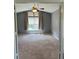 Bedroom featuring neutral carpet, ceiling fan, and window with curtains at 5988 W Crestline Ave, Littleton, CO 80123