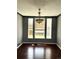 Bright dining room with hardwood floors and three large windows allowing ample sunlight at 5988 W Crestline Ave, Littleton, CO 80123