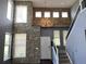 Grand entryway featuring soaring ceilings, stone accent wall, and a staircase at 5988 W Crestline Ave, Littleton, CO 80123