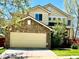 Charming two-story home featuring a stone-clad garage and well-maintained lawn at 5988 W Crestline Ave, Littleton, CO 80123