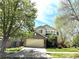 Traditional two-story house with a two car garage, trees and a manicured lawn at 5988 W Crestline Ave, Littleton, CO 80123