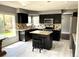 Well-appointed kitchen featuring an island, stainless steel appliances, and ample counter space at 5988 W Crestline Ave, Littleton, CO 80123