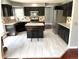 Spacious kitchen featuring an island, modern appliances, and stylish tile flooring at 5988 W Crestline Ave, Littleton, CO 80123