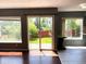 Open living room with hardwood floors, slider to the backyard, and large windows at 5988 W Crestline Ave, Littleton, CO 80123