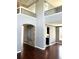 Bright living room featuring hardwood floors, stone accent wall and an upper balcony at 5988 W Crestline Ave, Littleton, CO 80123