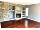 Cozy living room with a stone fireplace and built-in shelving at 5988 W Crestline Ave, Littleton, CO 80123