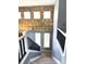 Carpeted staircase with stone wall and chandelier at 5988 W Crestline Ave, Littleton, CO 80123
