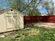 Fenced backyard with trees and a shed at 5988 W Crestline Ave, Littleton, CO 80123