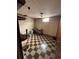 Unfinished basement featuring a checkered floor and a small window at 7795 Raritan St, Denver, CO 80221