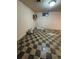 A large unfinished basement with checkerboard tile flooring, ready for customization at 7795 Raritan St, Denver, CO 80221