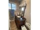 Well maintained bathroom with elegant vanity, mirror, and shower at 7795 Raritan St, Denver, CO 80221