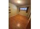 Cozy bedroom featuring hardwood floors, light green walls and a built-in shelf at 7795 Raritan St, Denver, CO 80221