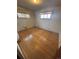 Bedroom featuring hardwood floors, neutral walls and large windows at 7795 Raritan St, Denver, CO 80221