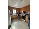 A functional kitchen with wooden cabinets, white appliances, and tile flooring at 7795 Raritan St, Denver, CO 80221