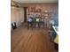 Living room features hardwood floors, wood paneling, shelving and multiple chairs at 7795 Raritan St, Denver, CO 80221