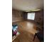 Spacious living room with hardwood flooring and natural light streaming through the window at 7795 Raritan St, Denver, CO 80221