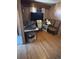 Living room with hardwood floors, wood paneling, television and multiple chairs at 7795 Raritan St, Denver, CO 80221