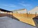 A backyard featuring a wood fence, gravel, and a covered concrete patio at 120 Sabin Way, Lochbuie, CO 80603