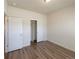 A bright bedroom featuring light walls, wood floors, and a closet with sliding doors at 120 Sabin Way, Lochbuie, CO 80603