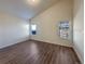 A bright bedroom with neutral walls, modern window, and wood-look floors at 120 Sabin Way, Lochbuie, CO 80603
