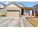 Charming home featuring a two-car garage, stone accents, and a welcoming front porch at 120 Sabin Way, Lochbuie, CO 80603