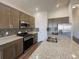 Modern kitchen with stainless steel appliances, granite countertops, and mosaic backsplash at 120 Sabin Way, Lochbuie, CO 80603