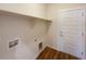 A laundry room with a shelf and utility hook-ups adjacent to an exterior door at 120 Sabin Way, Lochbuie, CO 80603