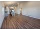Open-concept living room showcasing wood floors, high ceilings, and abundant natural light at 120 Sabin Way, Lochbuie, CO 80603