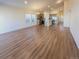 Bright, open-concept living area featuring wood floors and large windows at 120 Sabin Way, Lochbuie, CO 80603