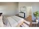 Staged main bedroom with ensuite bathroom and a modern dresser at 120 Sabin Way, Lochbuie, CO 80603