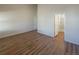 Spacious main bedroom with ensuite bathroom and wood-look flooring at 120 Sabin Way, Lochbuie, CO 80603