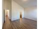 A spacious main bedroom with wood-look floors and an ensuite bathroom entrance at 120 Sabin Way, Lochbuie, CO 80603
