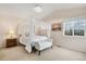 Light and airy bedroom featuring a canopy bed, bench and natural lighting at 24285 E Wagon Trail Ave, Aurora, CO 80016