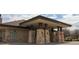 Commercial building entrance with stone pillars and a sheltered entryway, creating a welcoming first impression at 24285 E Wagon Trail Ave, Aurora, CO 80016