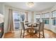 Cozy dining area with modern chandelier, fireplace, and sliding glass doors to the backyard at 24285 E Wagon Trail Ave, Aurora, CO 80016