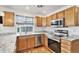 Well-lit kitchen with stainless steel appliances and granite countertops at 24285 E Wagon Trail Ave, Aurora, CO 80016