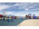 Community playground featuring slides, climbing structures, and a cushioned ground for safe play at 24285 E Wagon Trail Ave, Aurora, CO 80016